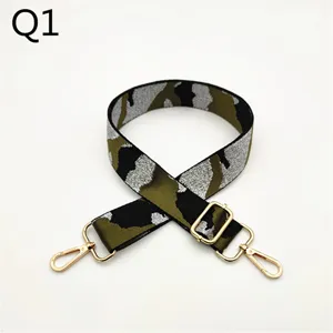 Camouflage bag strap detail shot, showing adjustable gold metal hardware and sturdy fabric.