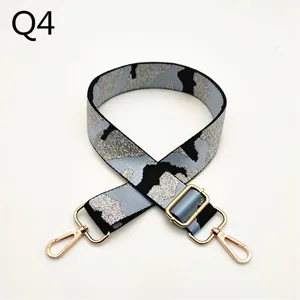 Adjustable camo replacement bag strap with shiny gold metal clasps and slider buckle detail.