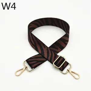Detail close-up of adjustable zebra pattern bag strap with gold metal hardware and clips.