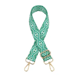 Correa de bolso tejida ajustable con patrón geométrico verde y herrajes dorados finos.