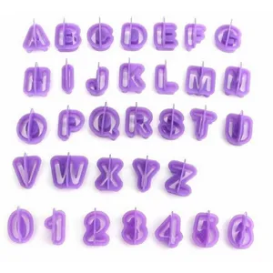 Detailed view of purple plastic letter and number cookie cutters for baking and cake decoration.