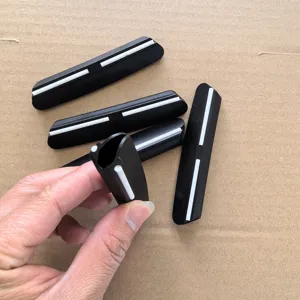 Detailed view of black fixed angle knife sharpener guide with white strip for sharpening stones.