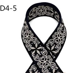Close up detail of ethnic style jacquard webbing ribbon with dark blue and beige pattern.