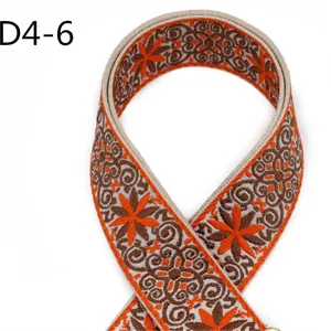 Close-up view of the 5cm ethnic jacquard webbing strap, boho style brown and orange floral pattern.