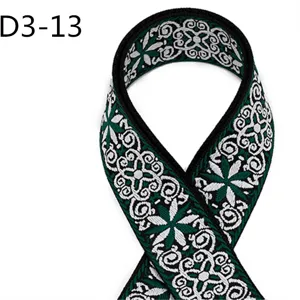 Close-up view of ethnic jacquard webbing strap detail, green and white woven pattern fabric.