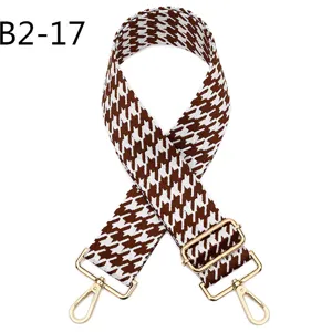 Brown white houndstooth replacement bag strap with adjustable gold metal hardware details.