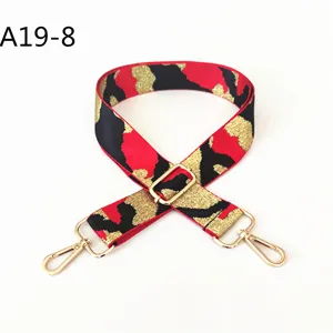 Replacement bag strap with red black gold jacquard camo pattern and gold metal hardware.