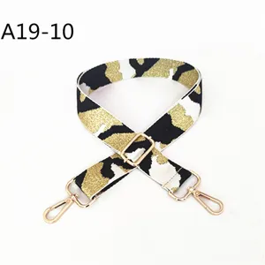 Jacquard camouflage replacement bag strap detail, adjustable length with gold metal hooks.