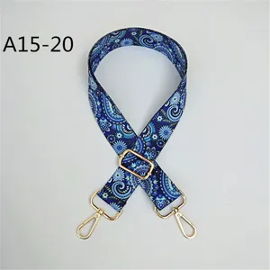 Vue détaillée de la bandoulière large ethnique à motif bleu avec quincaillerie dorée et boucle.