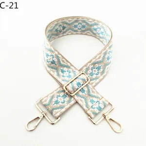 Ethnic style woven bag strap detail, replacement shoulder strap with gold hardware hooks.