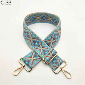 Ethnic woven replacement bag strap with adjustable gold metal hardware for shoulder bags.