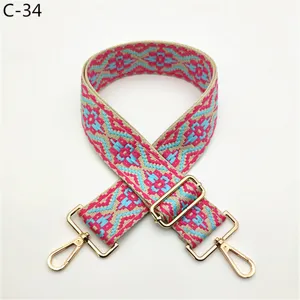 Ethnic style woven replacement bag strap with adjustable gold metal hardware for crossbody bags.