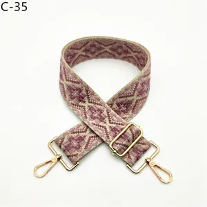 Ethnic style woven replacement bag strap with adjustable gold metal hardware for shoulder crossbody bags.