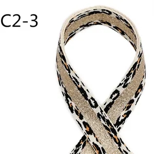 Detailed close-up shot of ethnic style leopard print jacquard webbing with metallic gold thread.