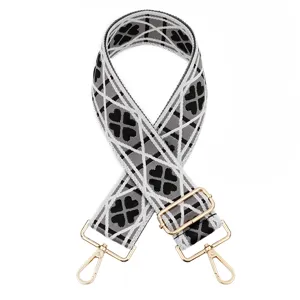 Ancha correa de bolso tejida de repuesto con elegante diseño de trébol negro y dorado.