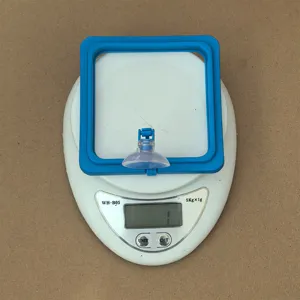 Fish feeding ring detail view on scale, blue square floating frame with suction cup.