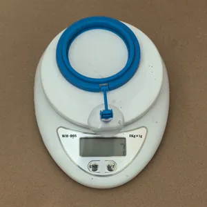 Detailed view of the blue plastic aquarium fish feeding ring with a clear suction cup.