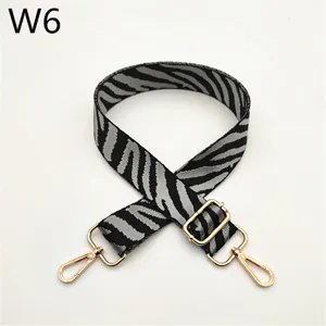 Detailed view of black and white zebra pattern replacement bag strap with gold metal hardware.