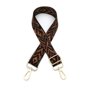 Replacement adjustable bag strap with geometric aztec pattern and gold metal hardware hooks for handbags.