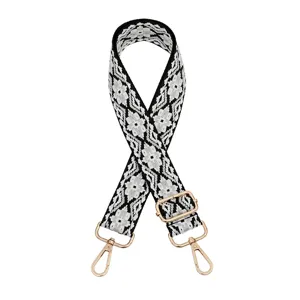 Detailed view of a black and white ethnic woven replacement bag strap with gold-tone hardware.
