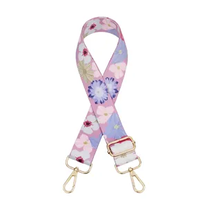 Detailed close-up of wide floral replacement bag strap with adjustable gold hardware for chic crossbody styles.