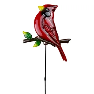 Metal cardinal garden stake detail showing vibrant red bird and green leaf design.