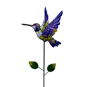 Close-up detail of the colorful metal hummingbird garden stake with vibrant stained glass wings.