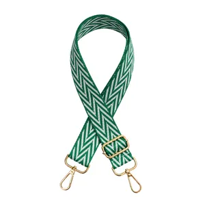 Green and white chevron pattern bag strap detail, adjustable gold metal hardware buckle.