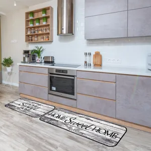 Detailed view of kitchen floor mats featuring wood grain design and sweet home text in modern home.