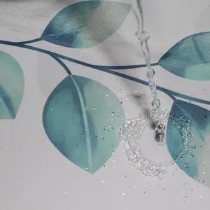 Waterproof polyester shower curtain with fresh green leaf pattern for modern bathroom decor.