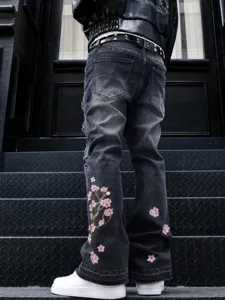 Men's black washed straight denim jeans with pink plum blossom embroidery, street fashion.
