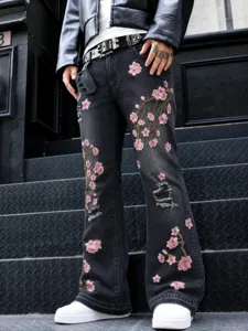 Men's black distressed denim jeans with pink floral cherry blossom embroidery and straight leg street style.