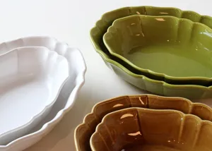 Retro ceramic oval baking dish detail view, featuring elegant wavy scalloped edges and glossy glaze.
