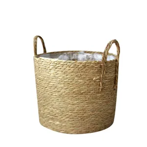 Woven seagrass storage basket with handles, ideal for home organization, plant pots and decor.