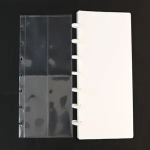 Close-up detail of discbound photocard binder with clear pockets and white cover page.