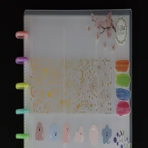 Close-up detail of translucent mushroom hole photocard binder with colorful disc rings and cute prints.