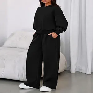 Black fleece-lined two-piece tracksuit featuring a hooded sweatshirt and wide-leg sweatpants.