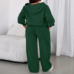 Back view detail of the dark green fleece-lined long sleeve hoodie and wide leg pants set.
