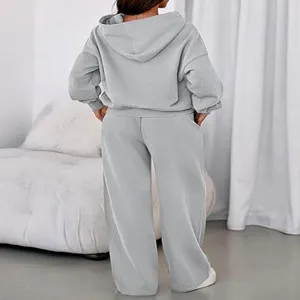 Detail view of the casual grey fleece-lined hooded sweatshirt and wide-leg trousers set.