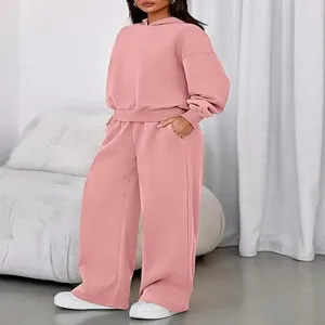 Cozy pink hooded sweatshirt and wide-leg sweatpants loungewear set detail view in room.