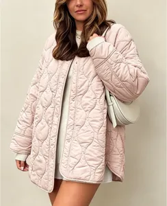 Detail view of women's loose round neck quilted padded jacket in pink, casual outerwear.