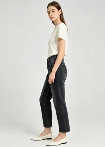 Close-up detail of women's casual distressed multi-button dark denim skinny trousers side view