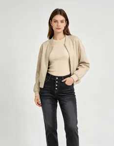 Detailed view of women's distressed washed multi-button slim fit denim jeans styled outfit.