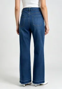 Back detail view of women high waisted loose straight leg denim jeans with raw frayed hem.