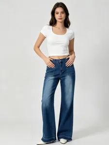 Women's white scoop neck crop top paired with high waist wide leg denim jeans casual outfit.
