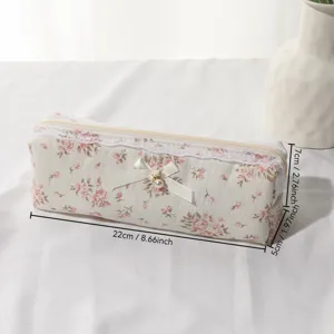 Cute floral lace pencil case and makeup brush storage bag with elegant pearl bow trim.