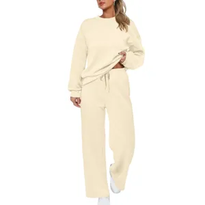 Beige knit tracksuit detail showing soft fabric, long sleeves, and comfortable wide-leg pants.