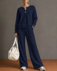 Detailed view of the women's navy blue V-neck long sleeve sweatshirt and wide leg pants set.