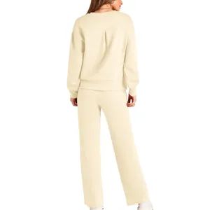Back view of beige knit lounge set featuring long sleeve sweater and wide-leg trousers.