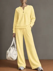 Detailed view of the casual yellow long sleeve sweatshirt and wide leg pants loungewear set.